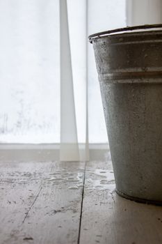 Bucket of water on the table in the cold. Close-up of an ice bucket on the background