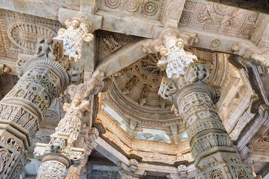 Columns pillars of beautiful Ranakpur Jain temple or Chaturmukha Dharana Vihara. Marble ancient medieval carved sculpture carvings of sacred place of jainism worship. Ranakpur, Rajasthan. India