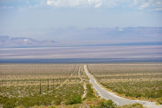 Endless desert road. Long straight road in desert. Adventure travel in a desert. California. USA