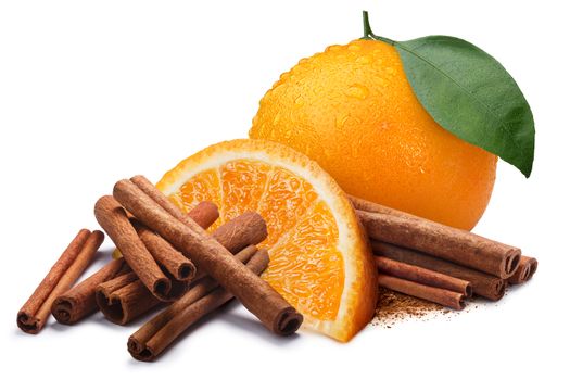 Whole and quarter of orange next to piles of cinnamon, in sticks and ground. Clipping paths, shadow separated