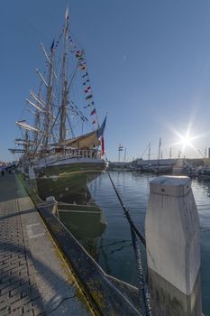 THE HAGUE, 21 June 2019 - Belem, antique French tall ship, vessel docking at  the harbor of The Hague, Scheveningen under a sunny and blue sky