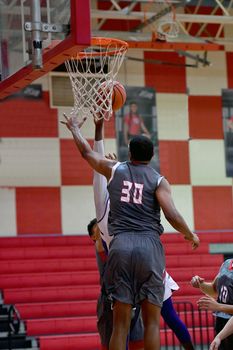 Young athletes making great basketball plays during a game. Slam Dunks and layups