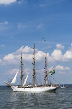 Antique tall ship, vessel leaving the harbor of The Hague, Scheveningen under a sunny and blue sky