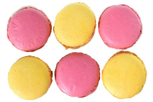 Pink strawberry and peach macarons top view isolated on white background