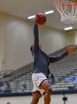 Young athletes making great basketball plays during a game. Slam Dunks and layups