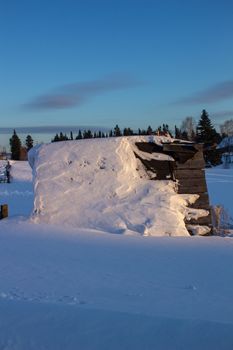 Wooden houses and fences covered with snow in Siberia, Russia