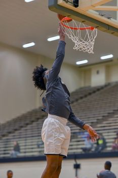 Young athletes making great basketball plays during a game. Slam Dunks and layups