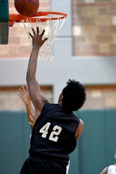 Young athletes making great basketball plays during a game. Slam Dunks and layups