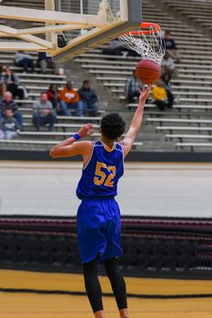 Young athletes making great basketball plays during a game. Slam Dunks and layups