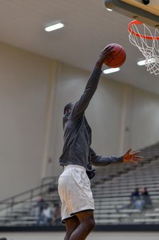 Young athletes making great basketball plays during a game. Slam Dunks and layups