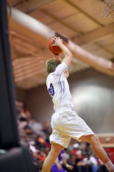 Young athletes making great basketball plays during a game. Slam Dunks and layups