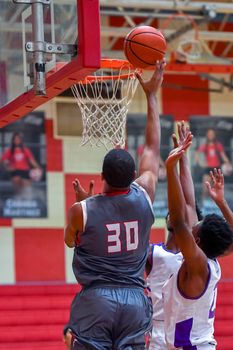 Young athletes making great basketball plays during a game. Slam Dunks and layups