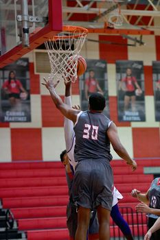 Young athletes making great basketball plays during a game. Slam Dunks and layups