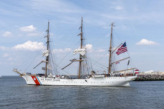 THE HAGUE, 23 June 2019 - US Coast Guard antique tall ship, vessel leaving the harbor of The Hague, Scheveningen under a sunny and blue sky
