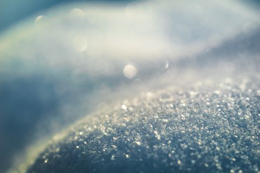Macro background of fresh snowflake texture on a blur.