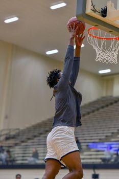 Young athletes making great basketball plays during a game. Slam Dunks and layups