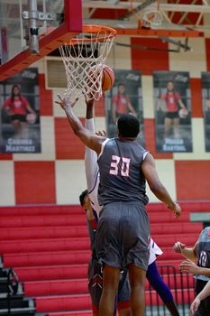 Young athletes making great basketball plays during a game. Slam Dunks and layups