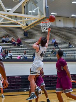 Young athletes making great basketball plays during a game. Slam Dunks and layups