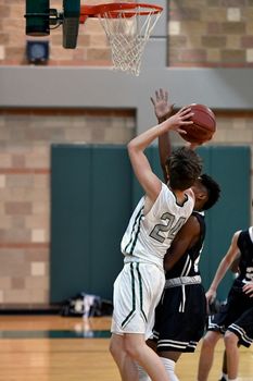 Young athletes making great basketball plays during a game. Slam Dunks and layups