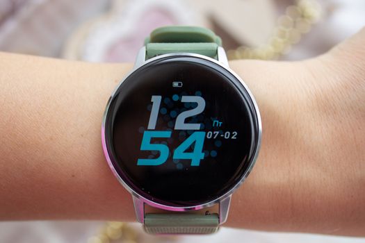 Digital watch with a large display on the girl s hand.
