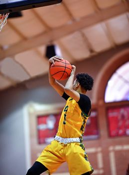 Young athletes making great slam dunks and lay ups during a basketball game