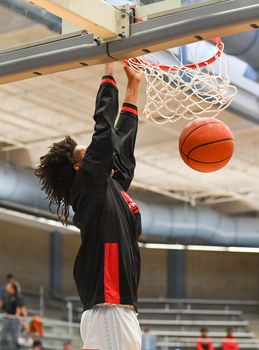 Young athletes making great basketball plays during a game. Slam Dunks and layups