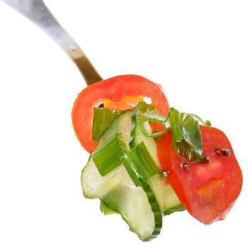 Fork with salad vegetables from tomato and cucumber isolated on a white background