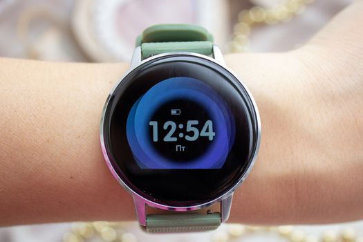 Digital watch with a large display on the girl s hand.
