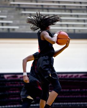 Young athletes making great basketball plays during a game. Slam Dunks and layups