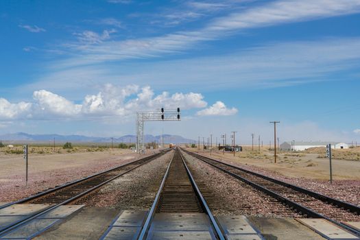 Railroad crossing gates on a road in the Mojave Desert in the Southwestern United States. California.