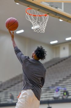 Young athletes making great basketball plays during a game. Slam Dunks and layups