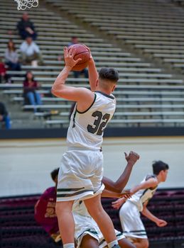 Young athletes making great basketball plays during a game. Slam Dunks and layups