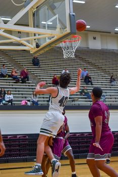 Young athletes making great basketball plays during a game. Slam Dunks and layups