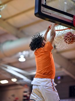 Young athletes making great basketball plays during a game. Slam Dunks and layups