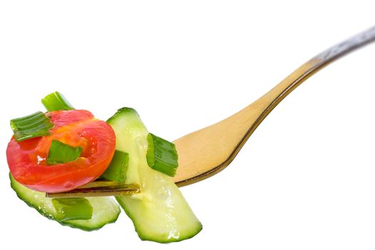 Fork with salad vegetables from tomato and cucumber isolated on a white background