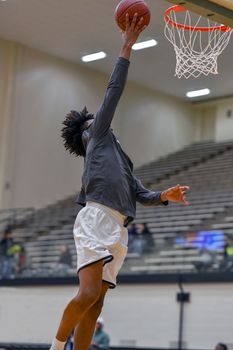 Young athletes making great basketball plays during a game. Slam Dunks and layups