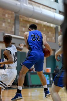 Young athletes making great basketball plays during a game. Slam Dunks and layups