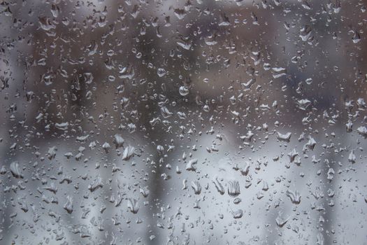 water drop, rain drop on glass and dripping down.