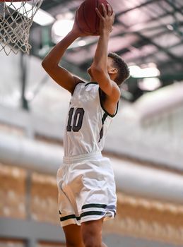 Young athletes making great basketball plays during a game. Slam Dunks and layups