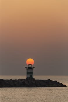 Sunset on the lighthouse of Scheveningen harbor at the summer hottest day ever