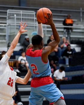 Young athletes making great basketball plays during a game. Slam Dunks and layups