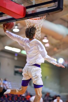 Young athletes making great slam dunks and lay ups during a basketball game