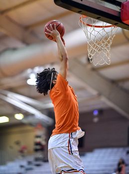 Young athletes making great slam dunks and lay ups during a basketball game