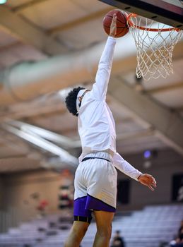 Young athletes making great basketball plays during a game. Slam Dunks and layups