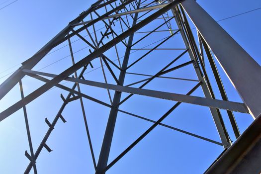 Close up view on a big power pylon transporting electricity in a countryside area in Europe