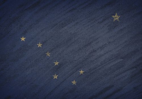 Close-up of national Alaska state flag painted with colored chalk on a blackboard.