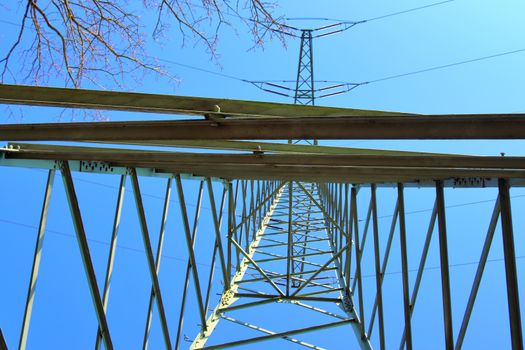 Close up view on a big power pylon transporting electricity in a countryside area in Europe