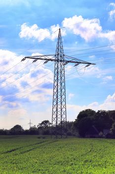 Close up view on a big power pylon transporting electricity in a countryside area in Europe