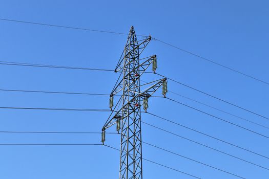 Close up view on a big power pylon transporting electricity in a countryside area in Europe