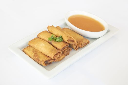 Chinese fried spring rolls served with a tomato spicy sauce